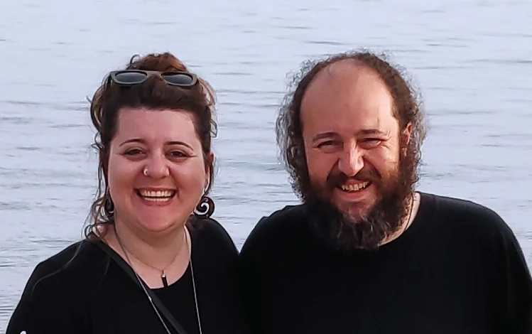 Katia and Van smiling by a lake
